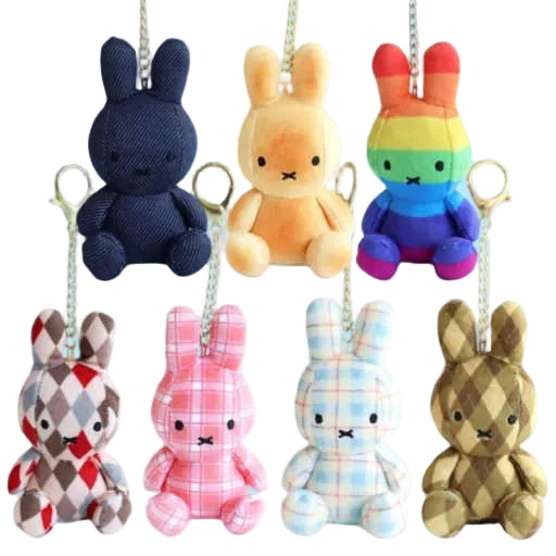 Set of colorful plush bunny keychains on a light blue background